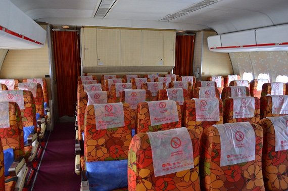 The front part of the plane, the overhead bins above the middle row are missing
