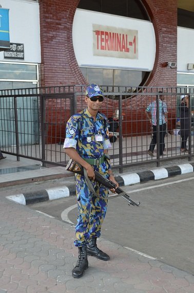 An airport police officer, posing for a picture