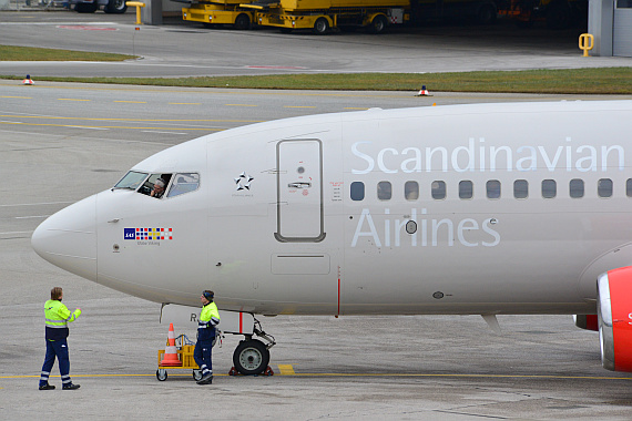 Der Kapitän einer 737-700 von SAS kommuniziert mit einem Mitarbeiter des Bodendienstes.